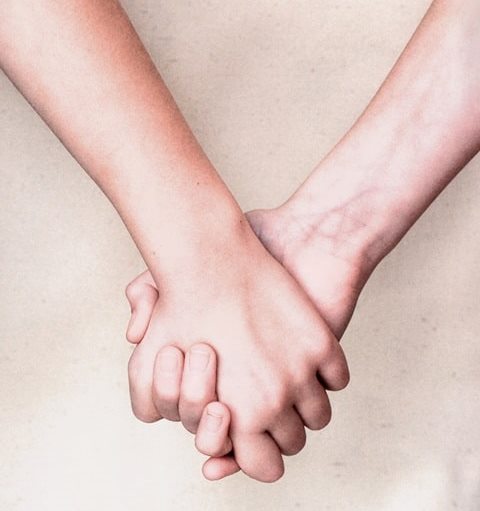 Two hands linked together
